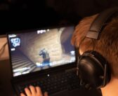 black headphones on black laptop computer