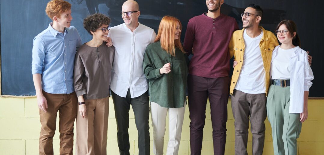 group of people standing beside chalk board