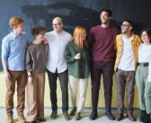 group of people standing beside chalk board